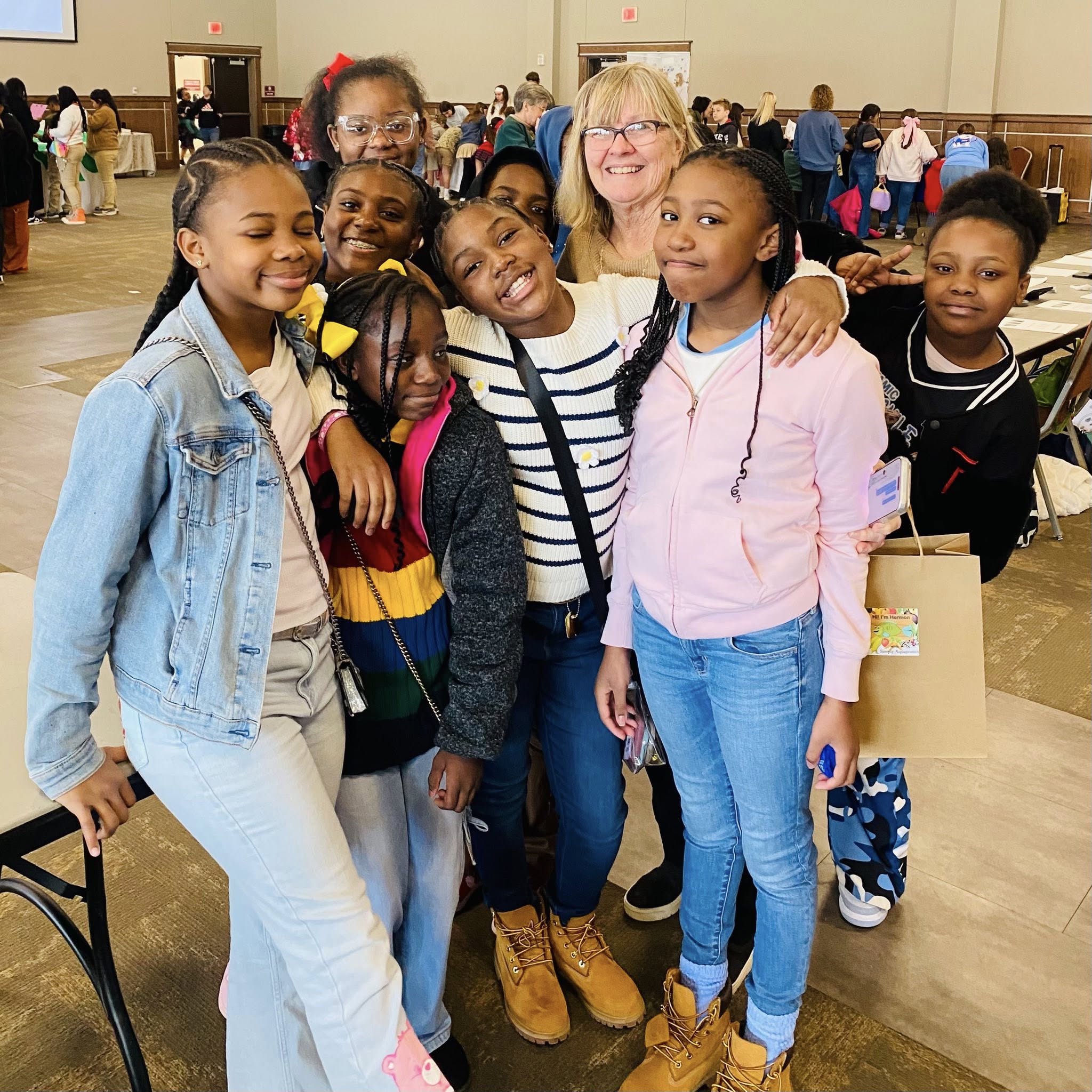 A woman and a small group of girls posing for a photo.